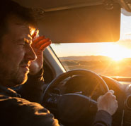 Low sun glare coming through a windshield at sunset